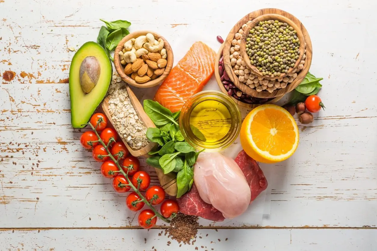 A heart shaped table with various foods on it.