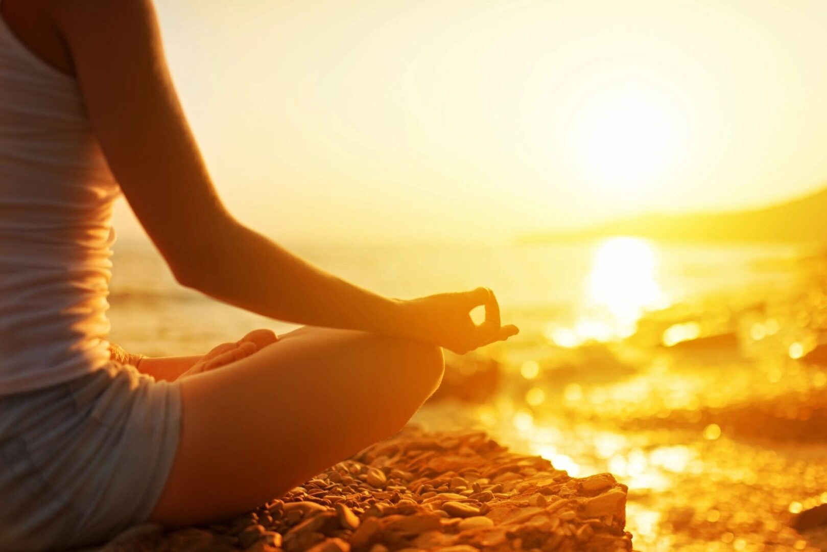 A person sitting on the beach in front of the ocean.